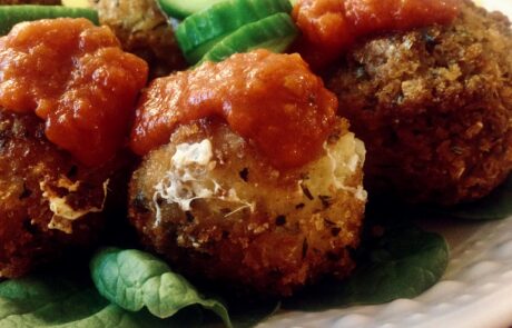 Arancine topped with marinara