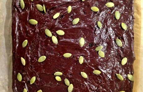 frosted brownies topped with pumpkin seeds