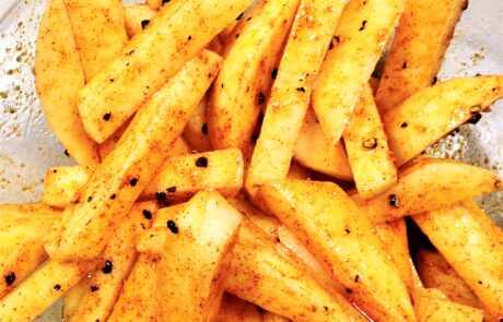 fries tossed in oil and seasoning