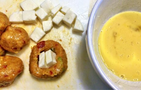 stuffing arancine to dip in egg bath