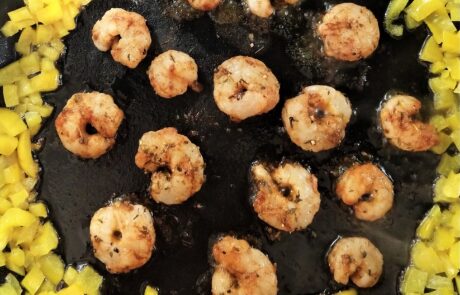 push the bell peppers to the edge of the pan, then blacken shrimp on each side